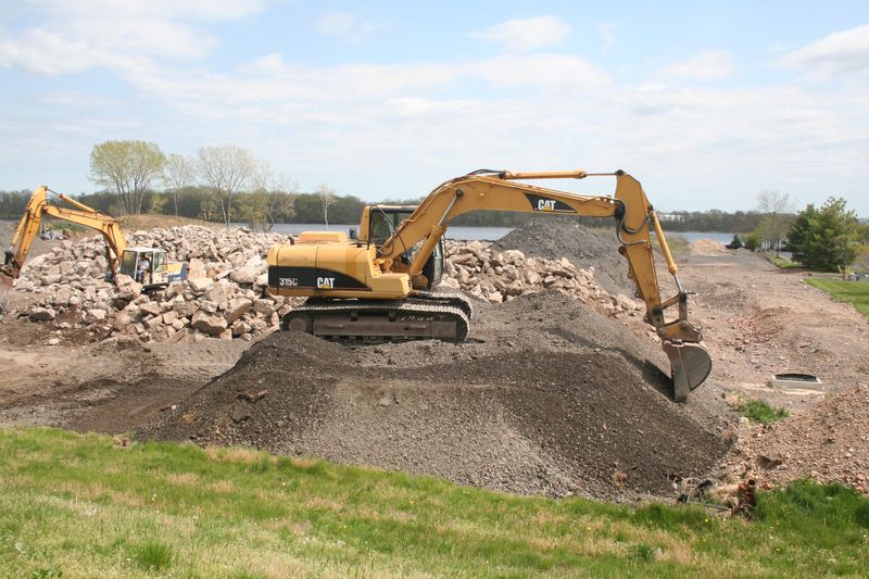 Excavators working a stockpile of broken concrete