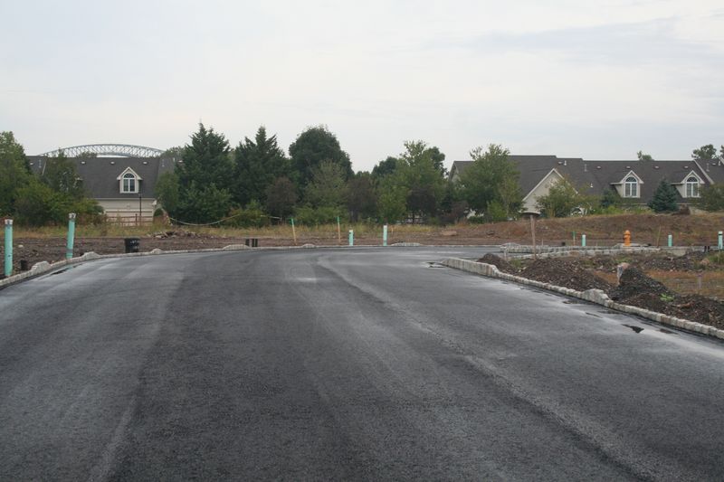 Freshly paved road with stone curbs in a new development