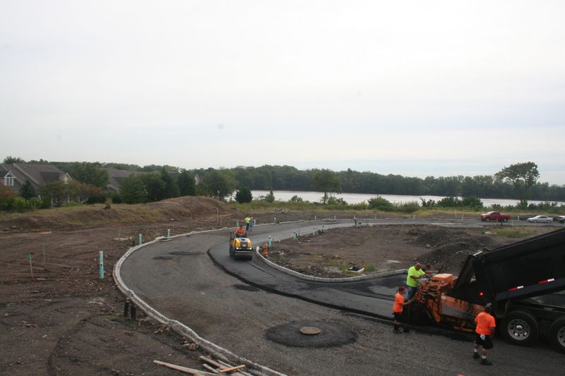 Crew paving a new curved road in a development