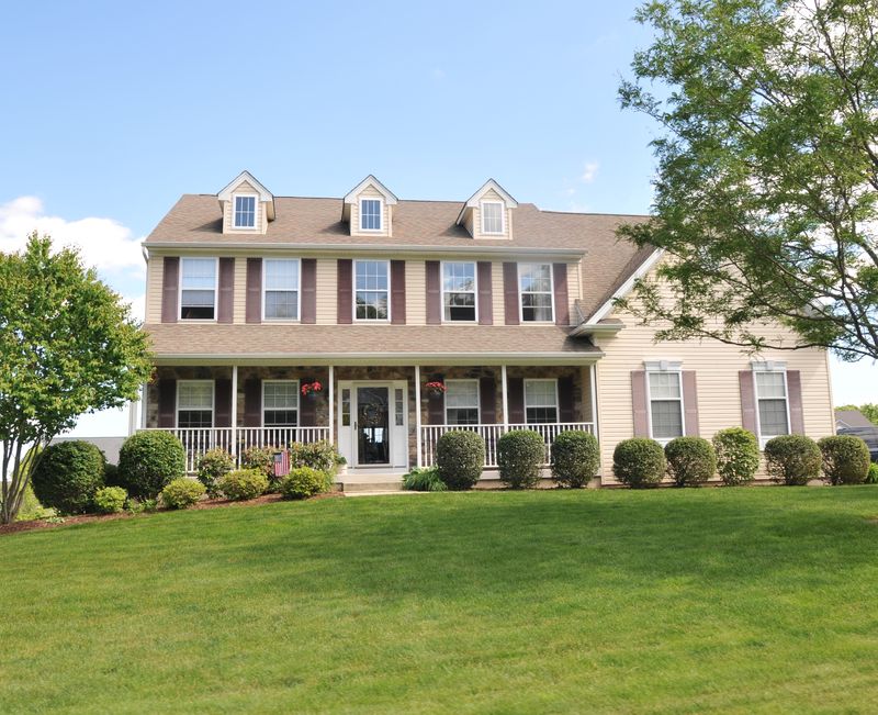 Colonial with a full front porch and three dormers