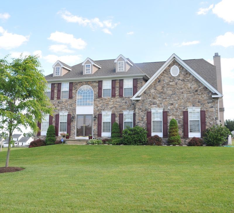 Two-story colonial with a full stone front