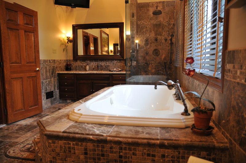 Primary bath with a tiled tub platform and vanity