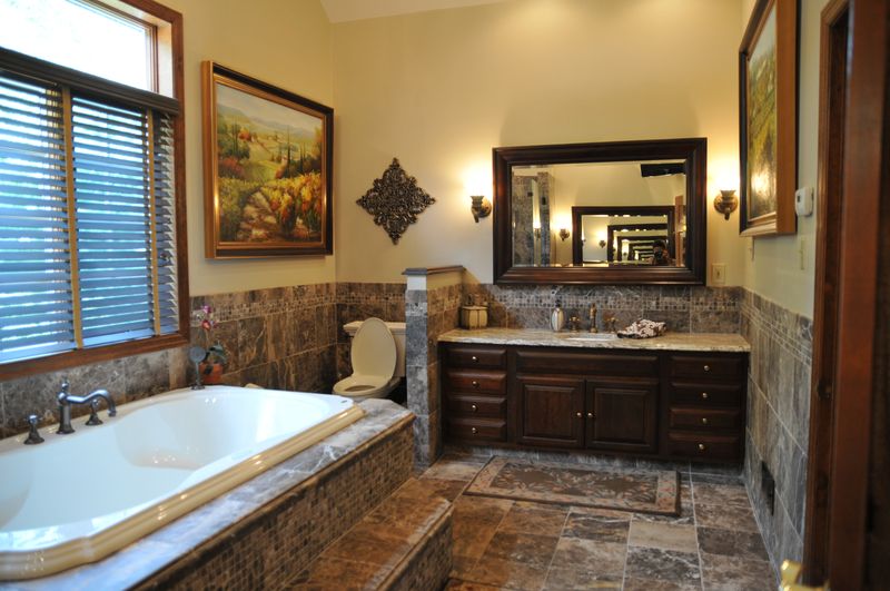 Primary bath with a soaking tub and wood vanity