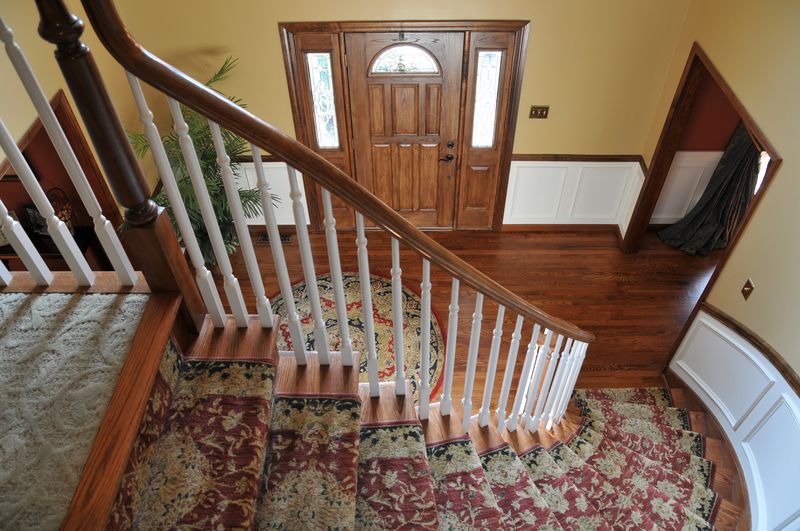 Curved staircase seen from the landing above the foyer